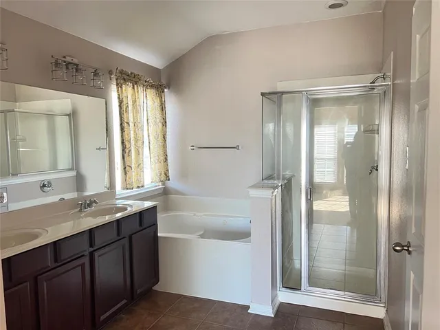 a bathroom with a double vanity sink and a mirror