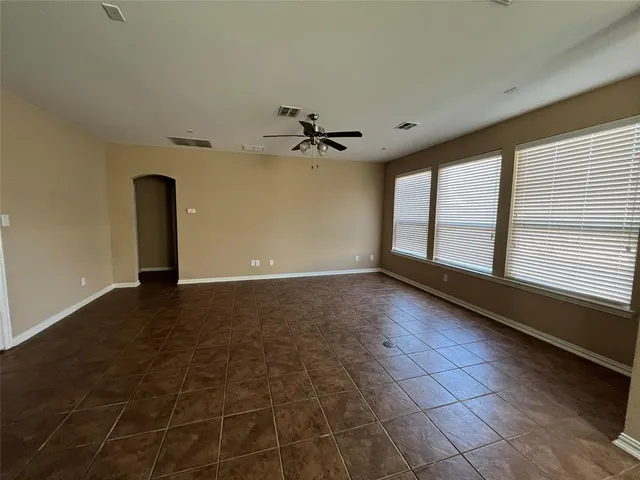a view of a livingroom with a ceiling fan and window