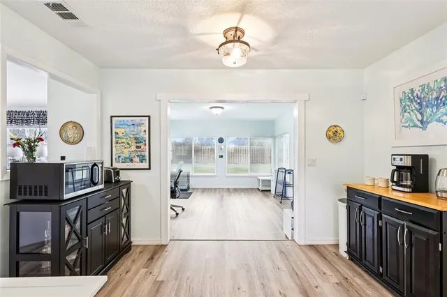 a view of kitchen with furniture and wooden floor