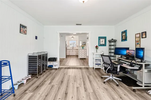 a view of a workspace with furniture and wooden floor