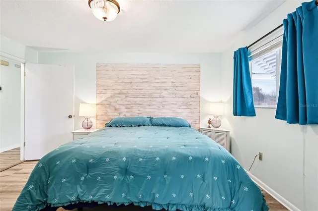 a bedroom with a bed and a window