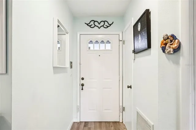 a view of front door with wooden floor
