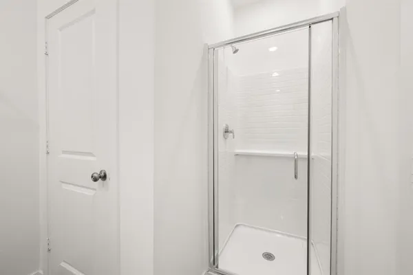a bathroom with a glass shower door
