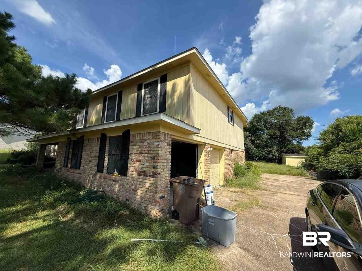 3721 Robertson Court Mobile, AL 36693 - Photo 2 of 22 View of side of home with brick siding and an attached garage