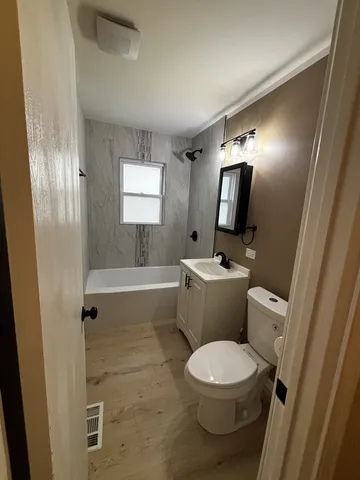 a bathroom with a toilet a sink and a mirror
