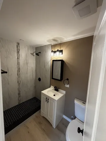 a bathroom with a sink toilet and shower