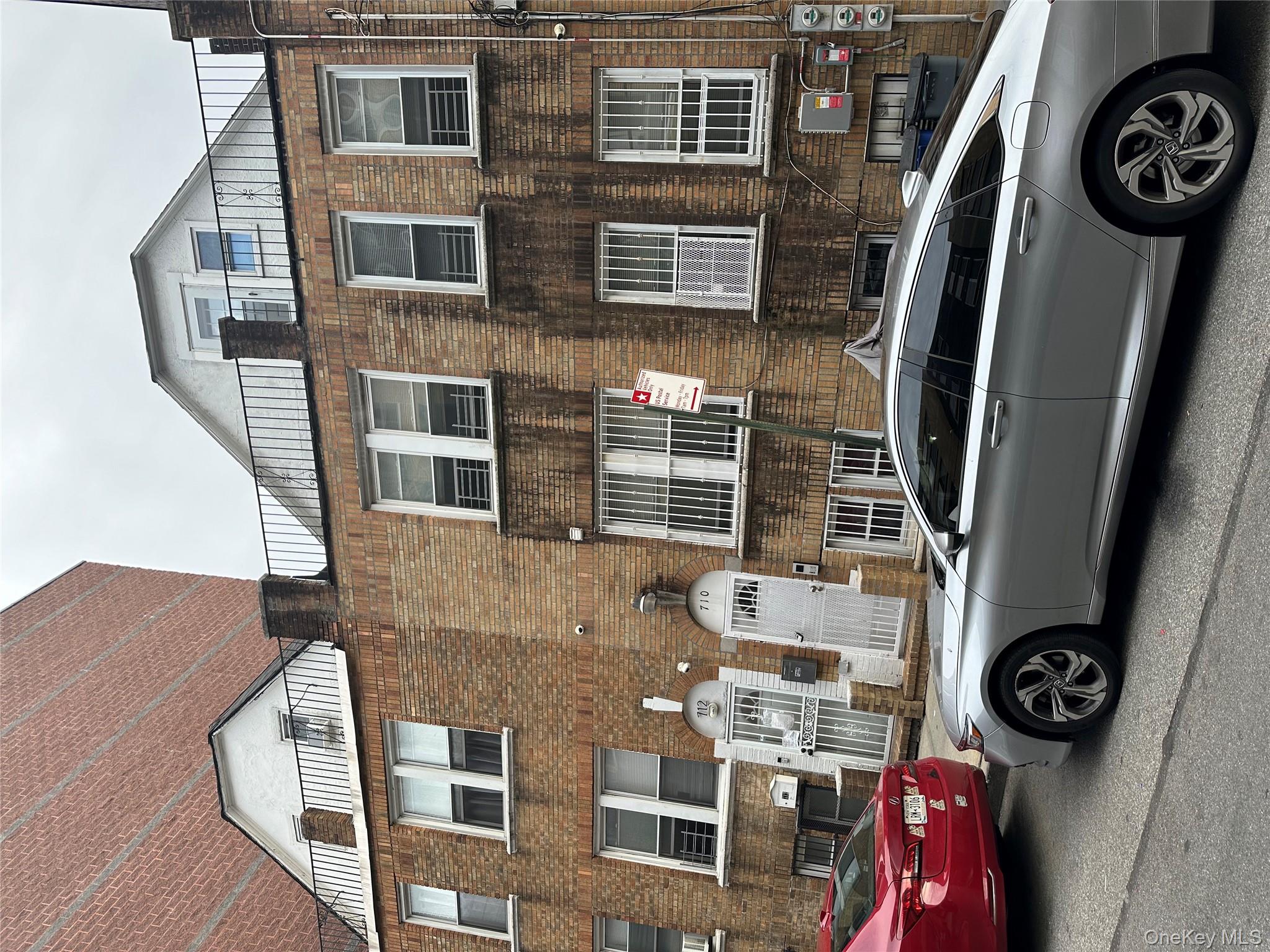 712 East 211th Street Bronx, NY 10467 - Photo 3 of 3 a front view of a house with parking space
