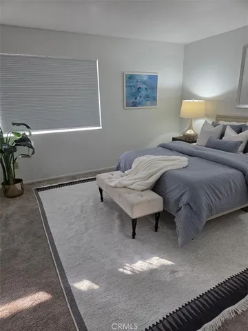 a bedroom with a bed and paintings on the wall