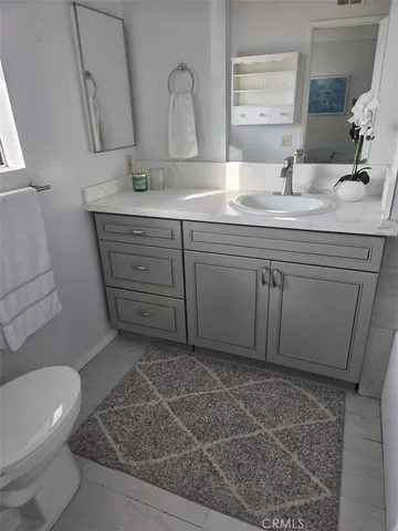 a bathroom with a sink a toilet and mirror