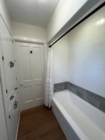 a bathroom with a bathtub and shower