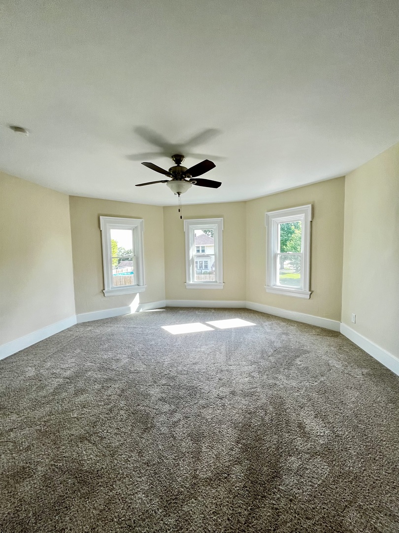 403 Uncas Street Tonica, IL 61370 - Photo 25 of 30 an empty room with windows and ceiling fan