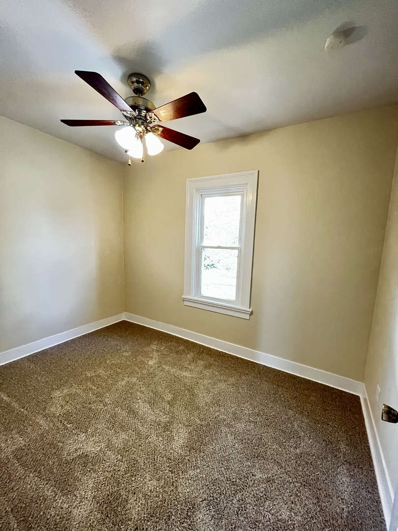 403 Uncas Street Tonica, IL 61370 - Photo 30 of 30 an empty room with a window and a fan