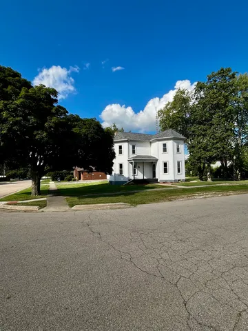 a view of a house with swimming pool and yard
