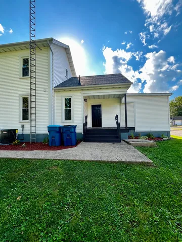 a front view of house with yard and outdoor seating