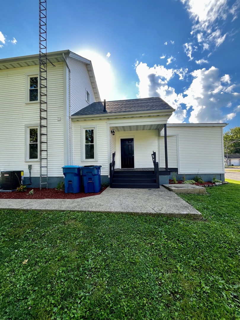 403 Uncas Street Tonica, IL 61370 - Photo 4 of 30 a front view of house with yard and outdoor seating