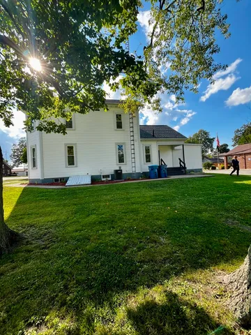 a view of a house with a backyard porch and sitting area