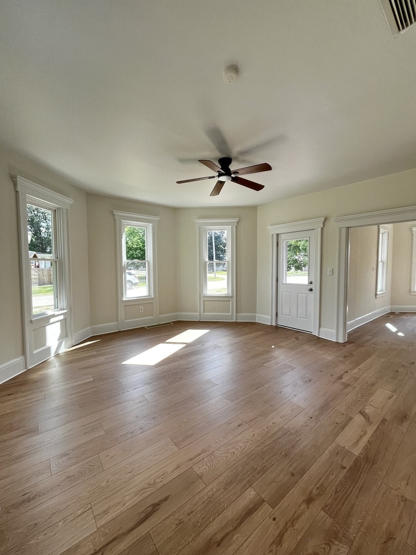 403 Uncas Street Tonica, IL 61370 - Photo 7 of 30 a view of empty room with wooden floor and fan