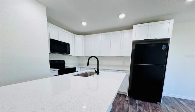 a kitchen with a sink and a refrigerator