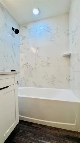 a bathroom with a bathtub and a shower