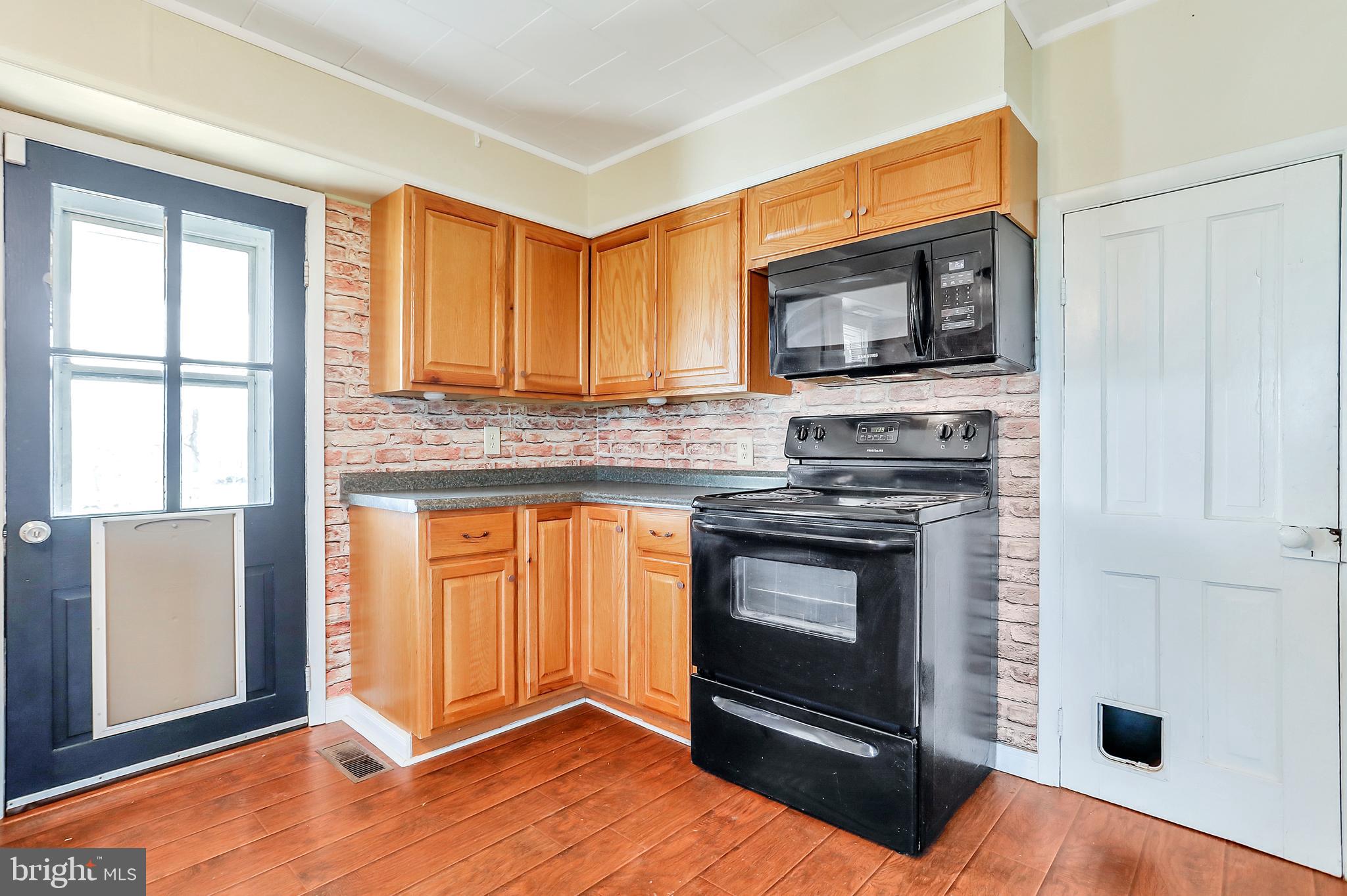 13837 Big Pool Road Clear Spring, MD 21722 - Photo 11 of 57 a kitchen with granite countertop a stove top oven and cabinets