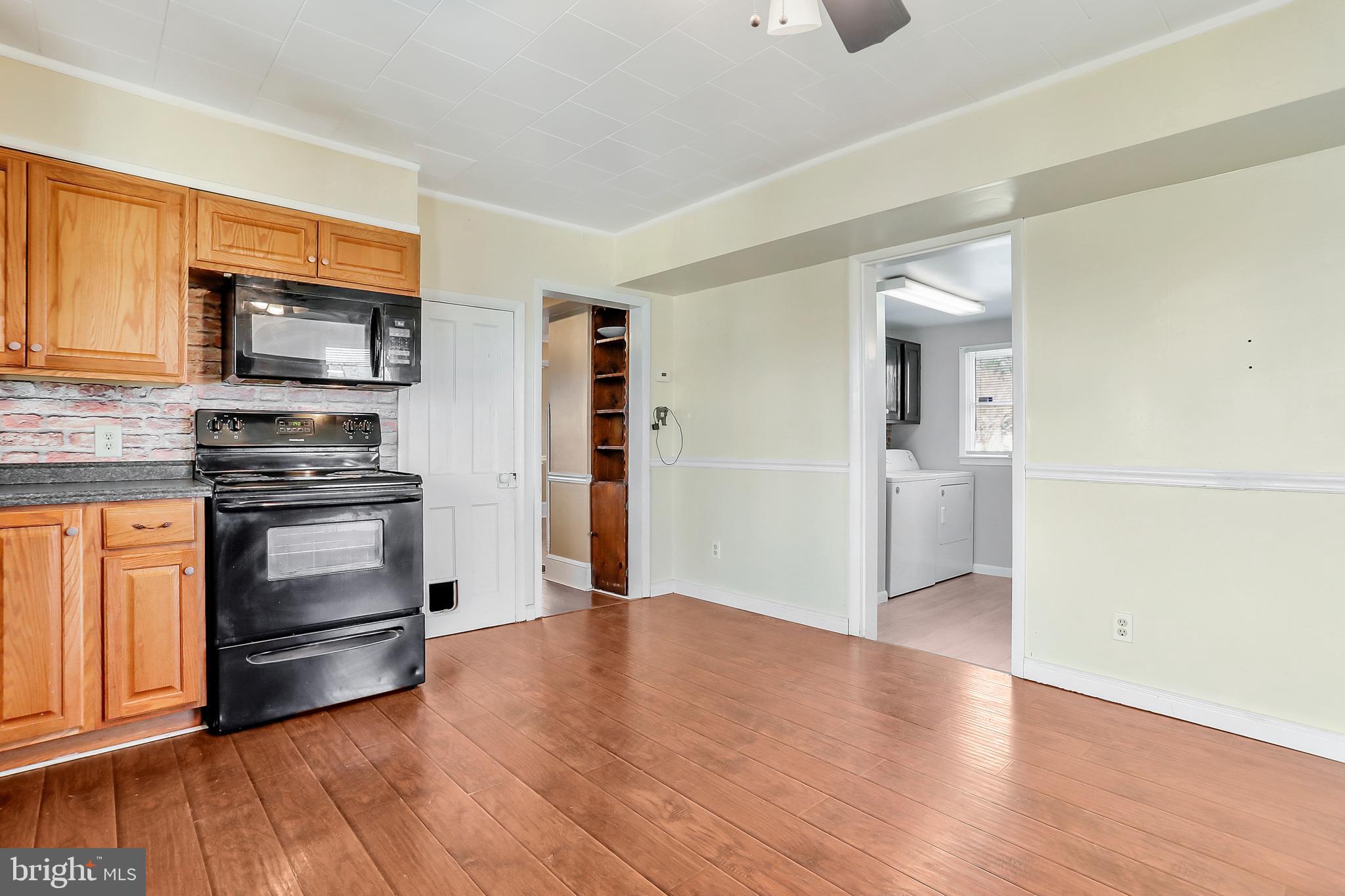 13837 Big Pool Road Clear Spring, MD 21722 - Photo 13 of 57 a kitchen with granite countertop a refrigerator and a stove top oven