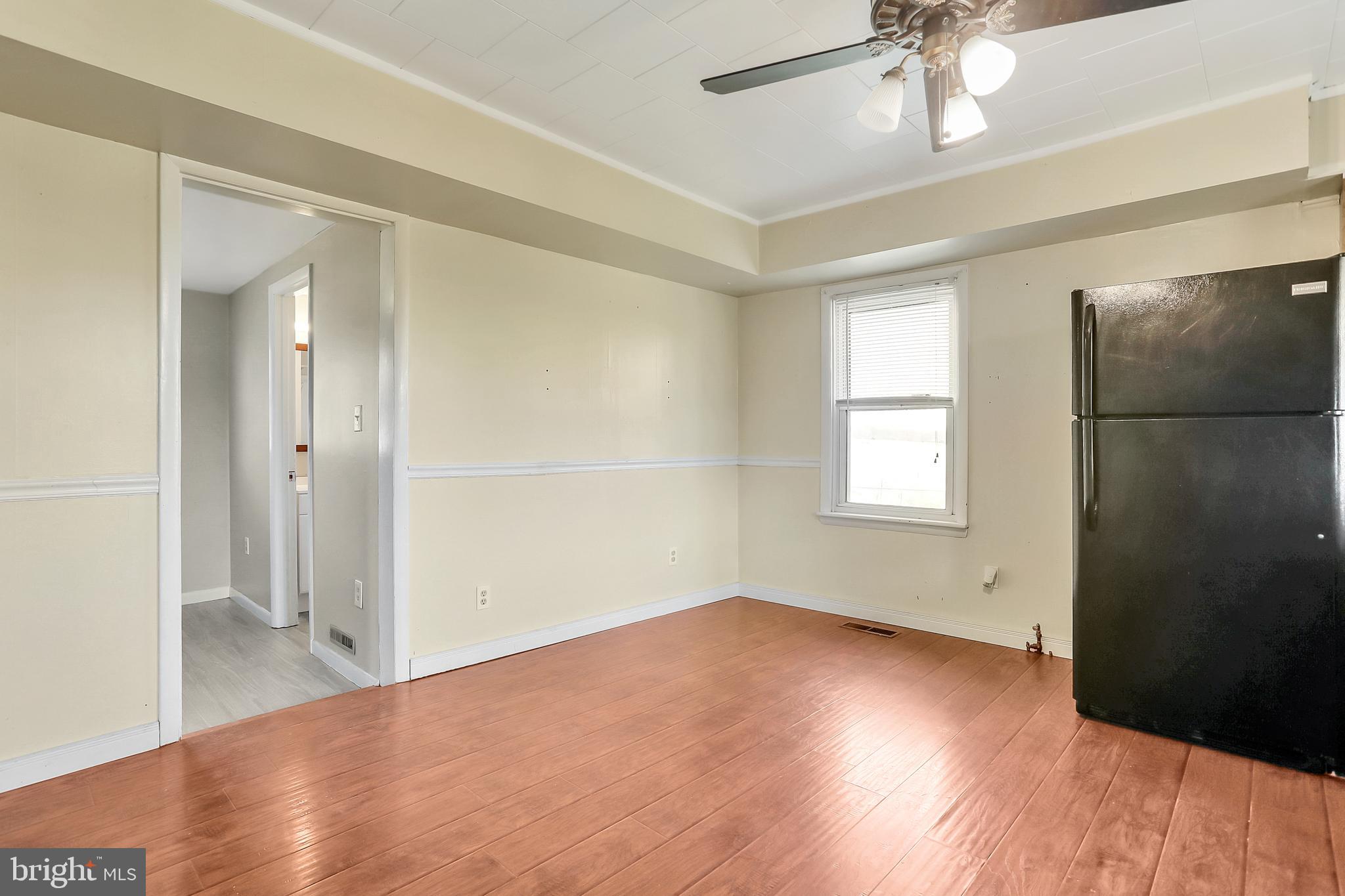13837 Big Pool Road Clear Spring, MD 21722 - Photo 14 of 57 wooden floor in an empty room with a window
