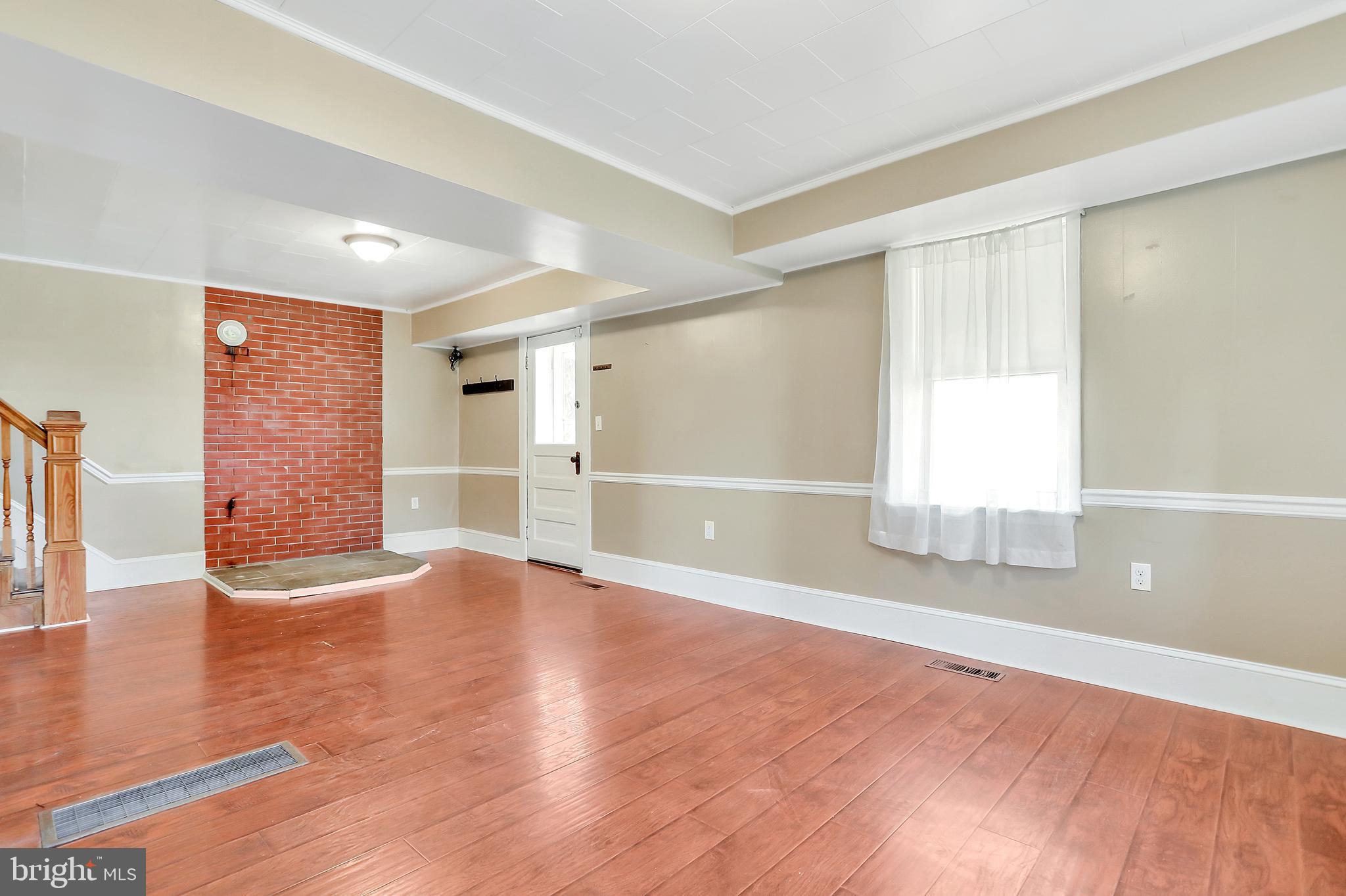 13837 Big Pool Road Clear Spring, MD 21722 - Photo 7 of 57 an empty room with wooden floor and windows