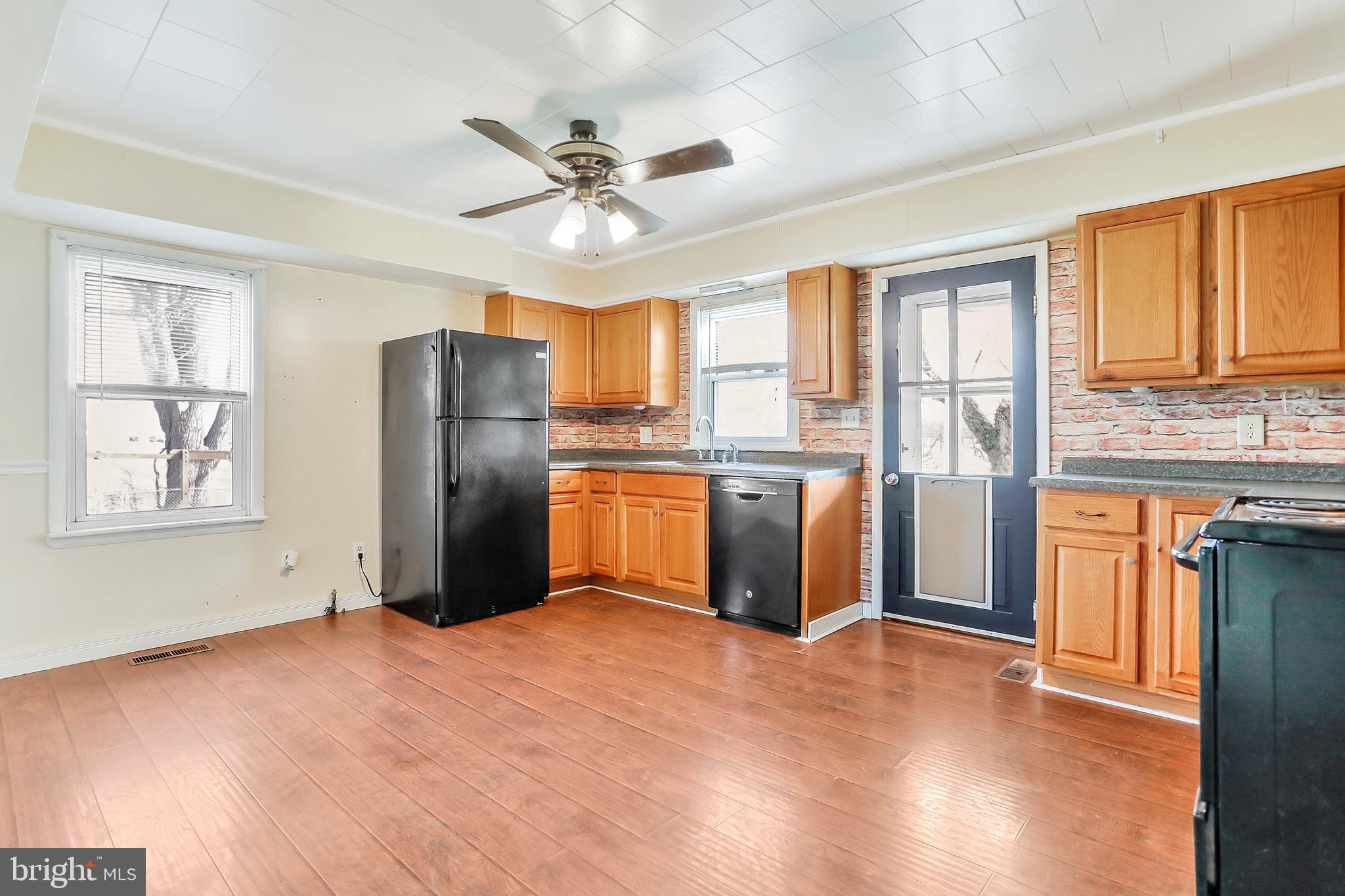 13837 Big Pool Road Clear Spring, MD 21722 - Photo 9 of 57 a kitchen with stainless steel appliances a refrigerator and wooden floor