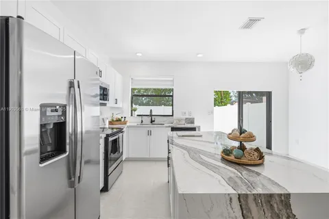 a kitchen with refrigerator and window