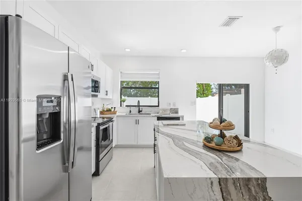 a kitchen with refrigerator and window