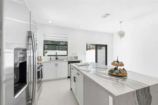 a kitchen with a sink stove and refrigerator