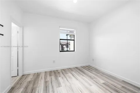 a view of a room with wooden floor