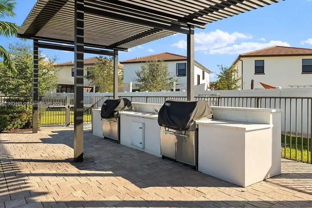 an aerial view of residential houses with outdoor space and swimming pool