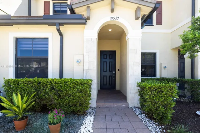 a front view of a house with a garden