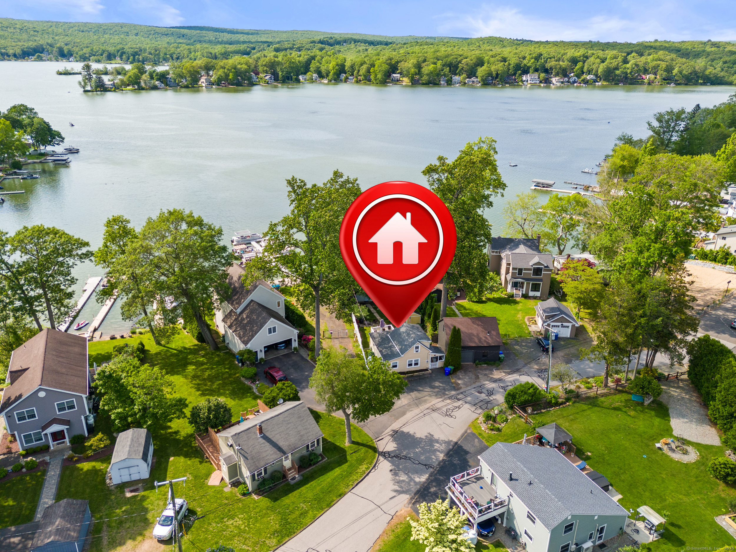 an aerial view of a house with outdoor space and lake view