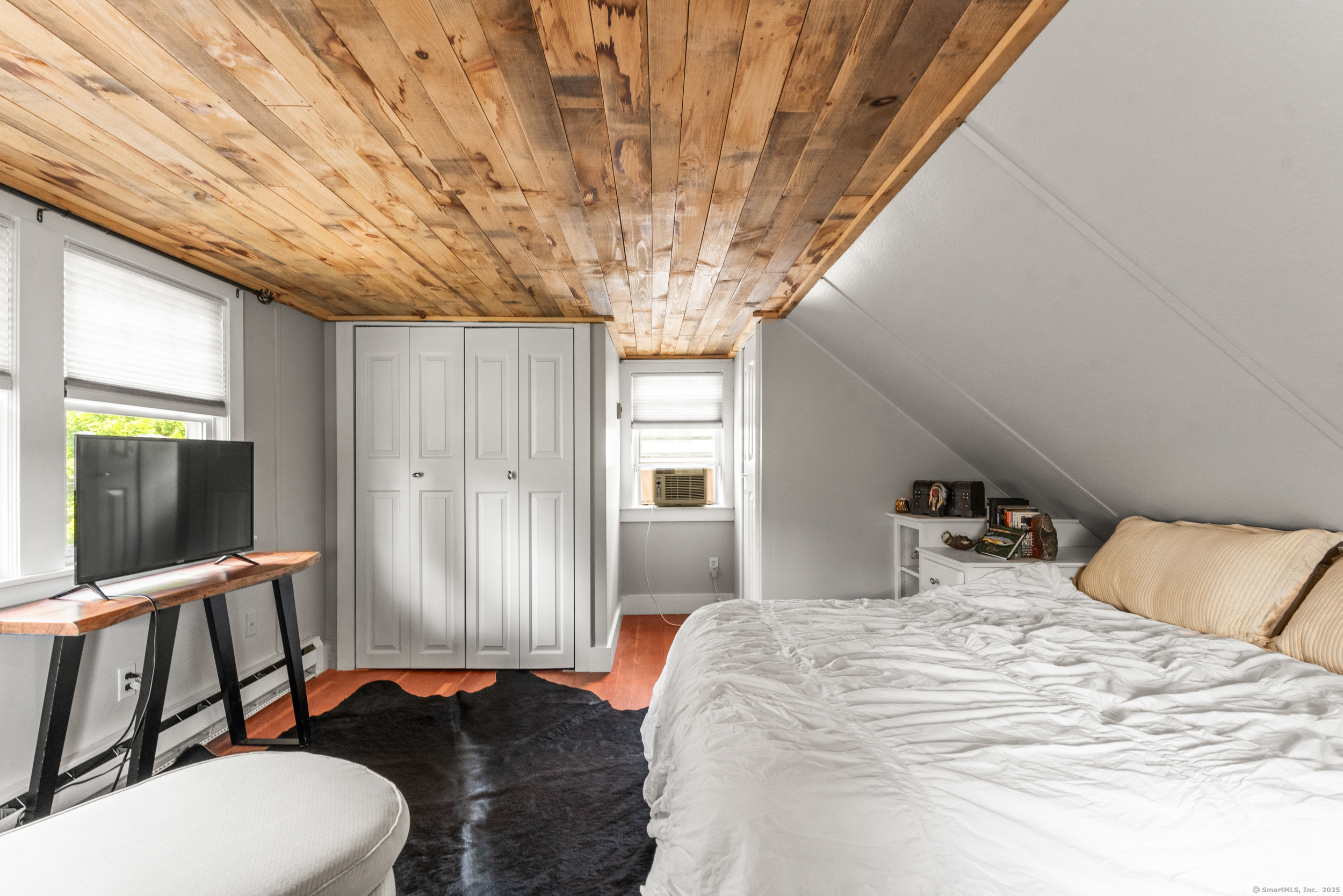 15 Hawthorne Road East Hampton, CT 06424 - Photo 13 of 19 a bedroom with a bed and large windows