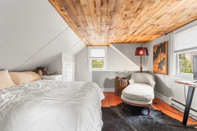 a bedroom with furniture and a window