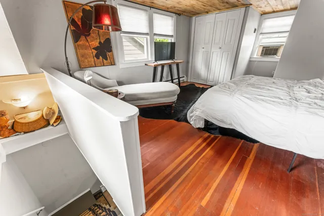 a bedroom with two beds and a large window