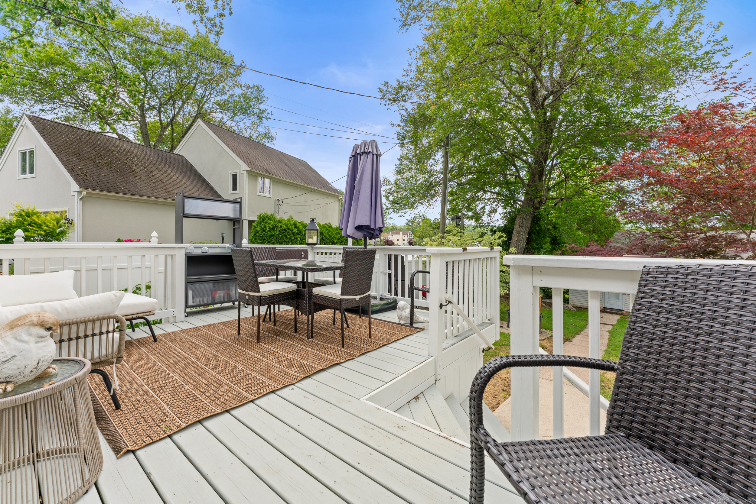 15 Hawthorne Road East Hampton, CT 06424 - Photo 19 of 19 a view of a patio with a dining table and chairs with wooden floor and fence