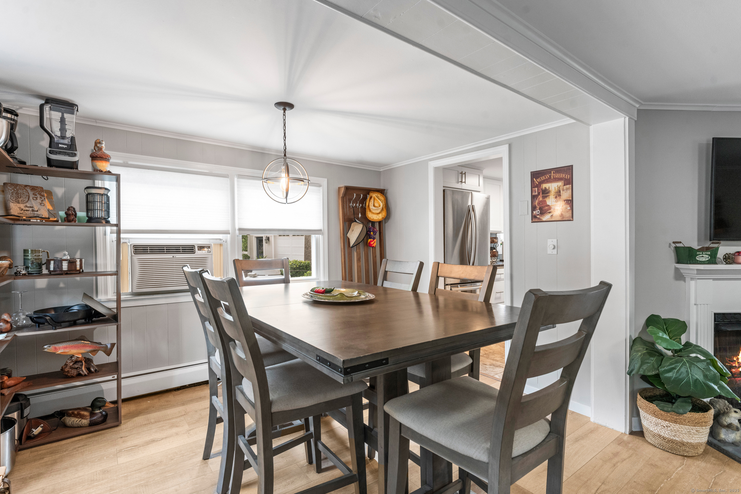15 Hawthorne Road East Hampton, CT 06424 - Photo 5 of 19 a view of a dining room and livingroom with furniture wooden floor a rug a painting and a chandelier