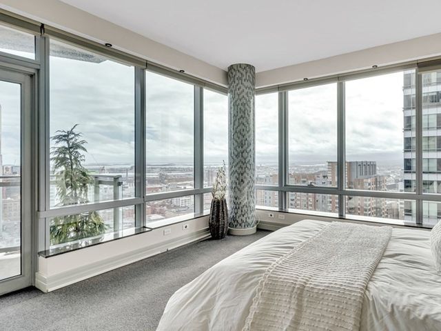 a spacious bedroom with a large bed and a large window