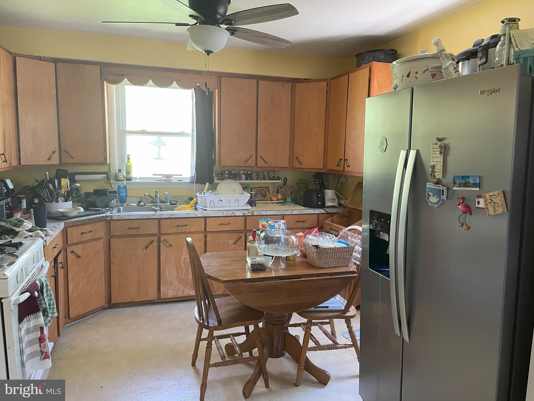 18006 Trossbach Road Dameron, MD 20628 - Photo 5 of 17 a kitchen with a table chairs refrigerator and cabinets