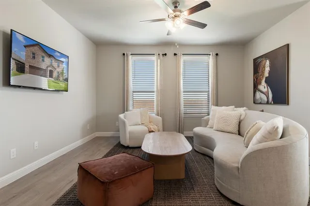 a living room with furniture and a large window