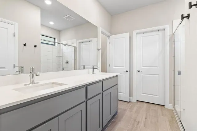 a bathroom with a double vanity sink mirror and double
