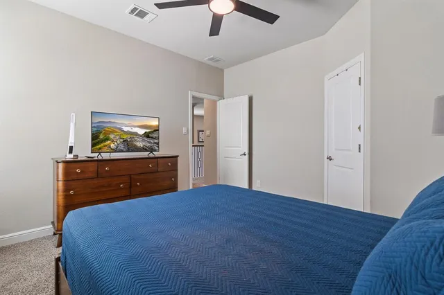 a bedroom with a bed and a dresser