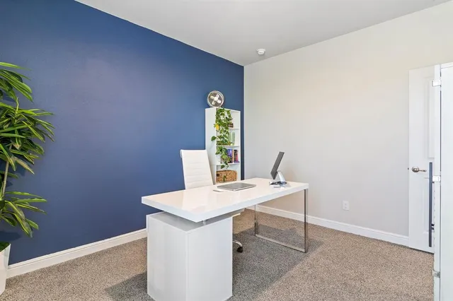 a workspace with furniture and a potted plant