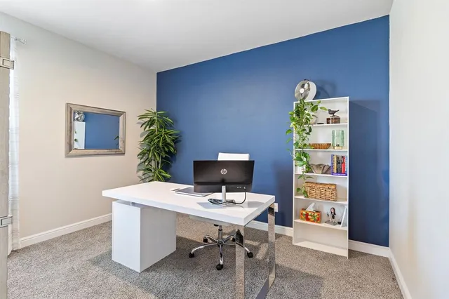 a workspace with furniture and window