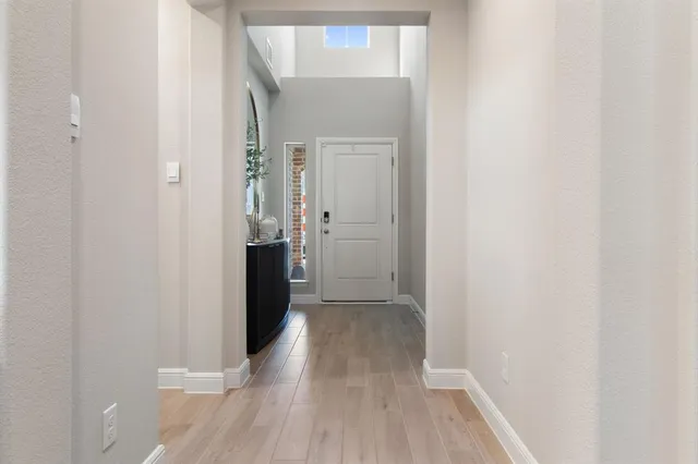 a view of a hallway with wooden floor