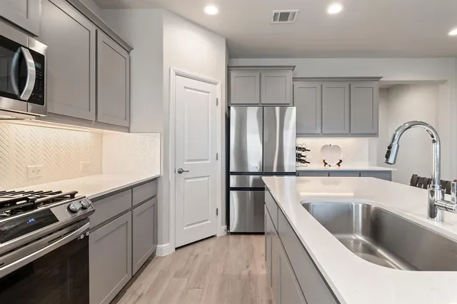 a kitchen with a sink stove and refrigerator