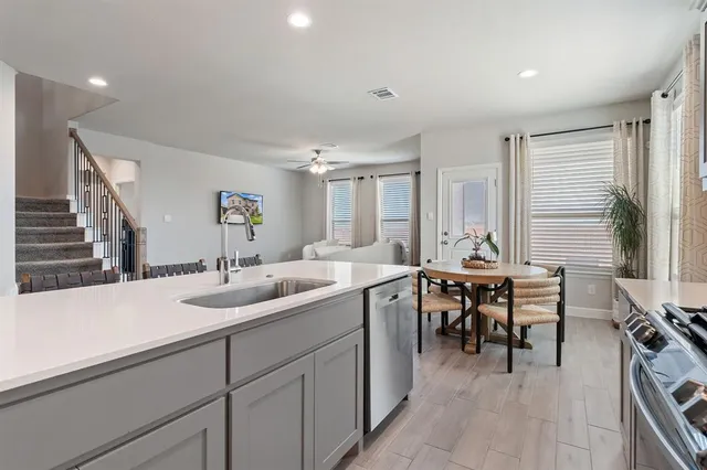 a kitchen with sink and cabinets